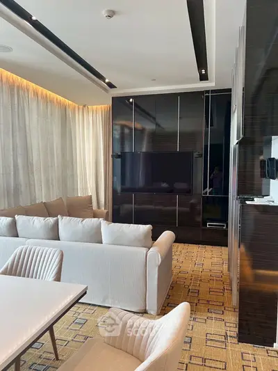 Luxurious modern living room with sleek black accents and plush beige seating