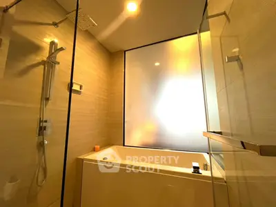 Luxurious bathroom with modern shower and bathtub in elegant real estate property.