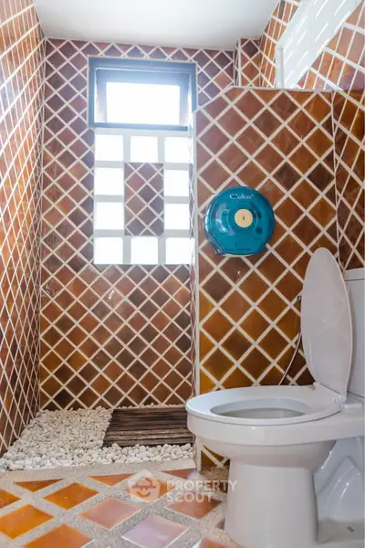 Stylish bathroom with unique tile design and modern fixtures.