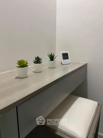 Modern study nook with sleek desk, minimalist decor, and digital clock, perfect for productivity.