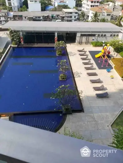 Luxurious rooftop pool with lounging area and children's playground, offering a serene oasis amidst the urban landscape, perfect for relaxation and family fun.