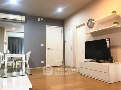 Modern living room with sleek furniture and wooden flooring in a stylish apartment.