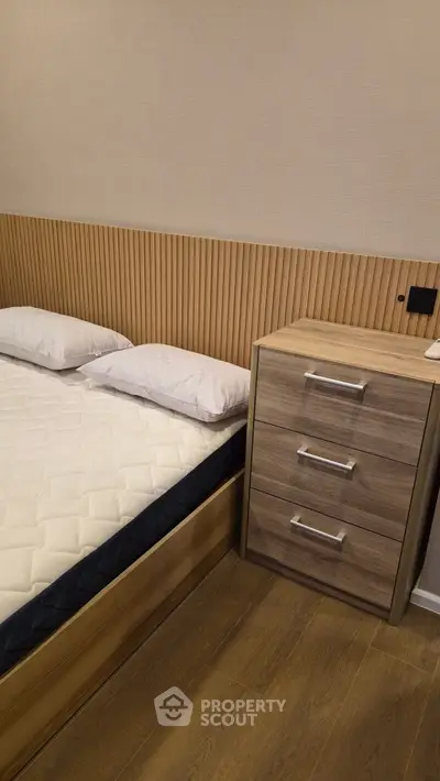 Modern bedroom with stylish wooden headboard and sleek nightstand