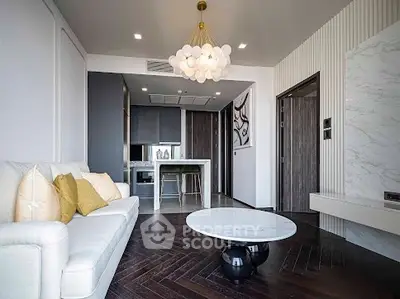 Modern living room with elegant chandelier and open kitchen layout