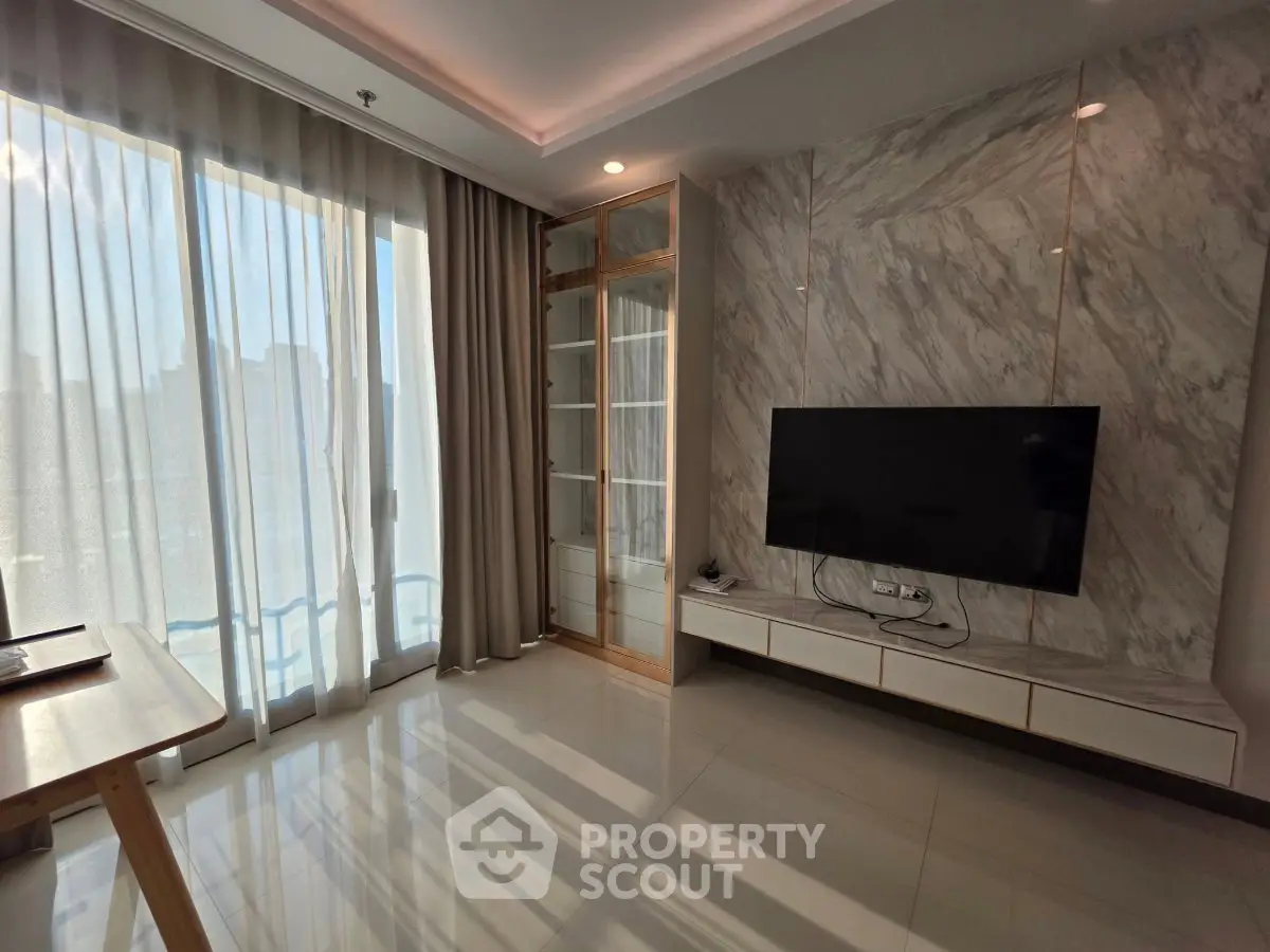 Modern living room with large windows and sleek TV setup