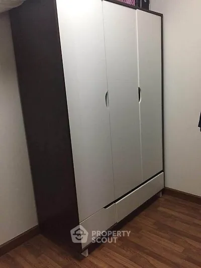 Spacious wardrobe in a modern bedroom with wooden flooring, perfect for ample storage.