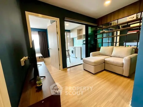 Modern living room with cozy sofa and open kitchen layout