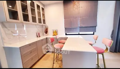 Modern kitchen with sleek cabinets and stylish bar stools
