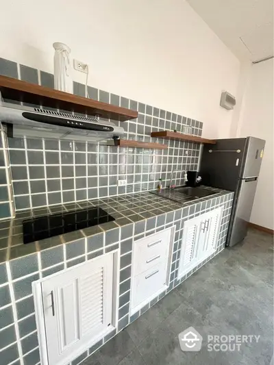 Modern kitchen with stylish tiled backsplash and sleek appliances