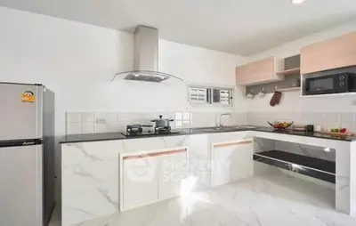 Modern kitchen with sleek marble countertops and stainless steel appliances