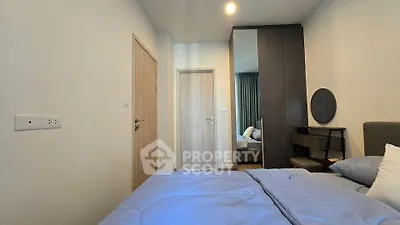 Modern bedroom with stylish decor and cozy bedding in a contemporary apartment.