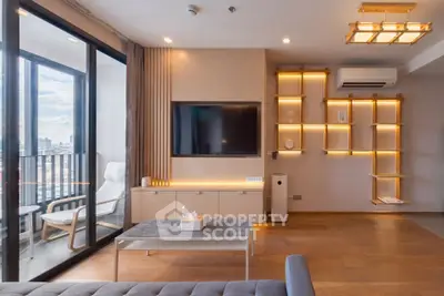 Modern living room with stylish furniture and balcony view in a high-rise apartment.