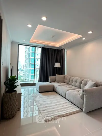 Modern living room with plush sofa and city view in high-rise apartment