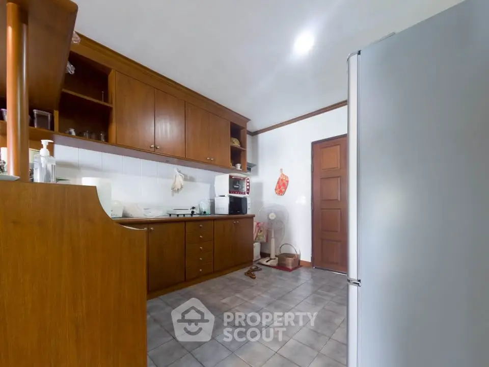 Spacious kitchen with wooden cabinets and modern appliances