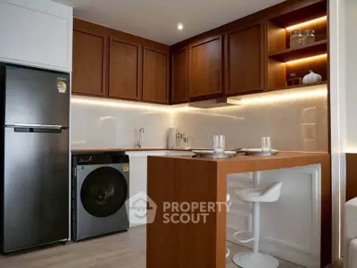 Modern kitchen with sleek wooden cabinets and integrated appliances