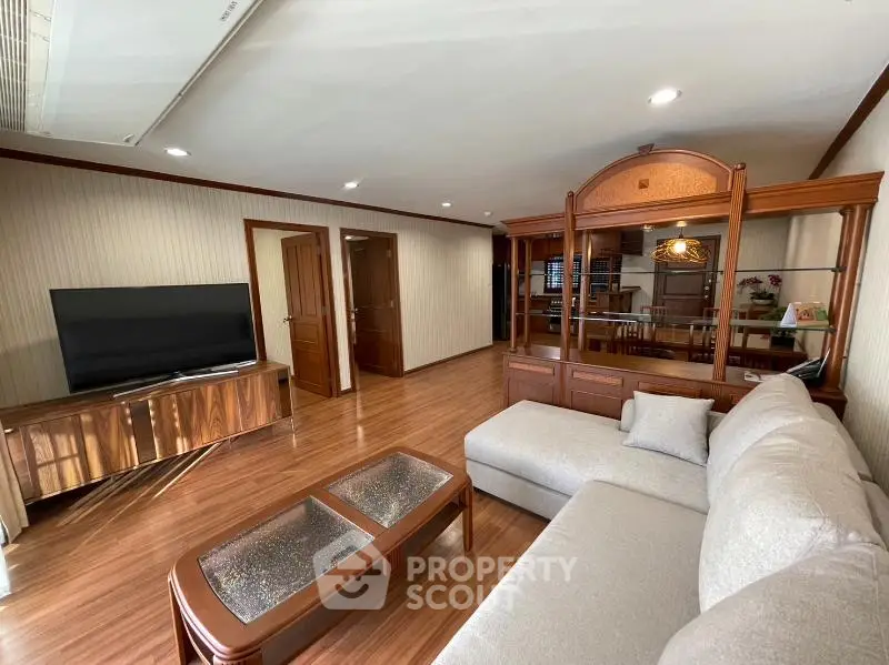 Spacious living room with elegant wooden flooring and modern furniture