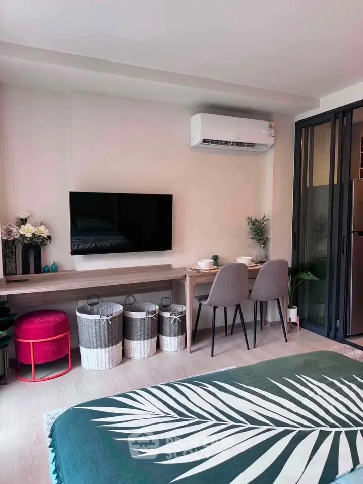 Modern living room with stylish decor, air conditioning, and cozy dining area in a contemporary apartment.