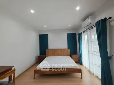 Spacious bedroom with modern wooden furniture and natural light