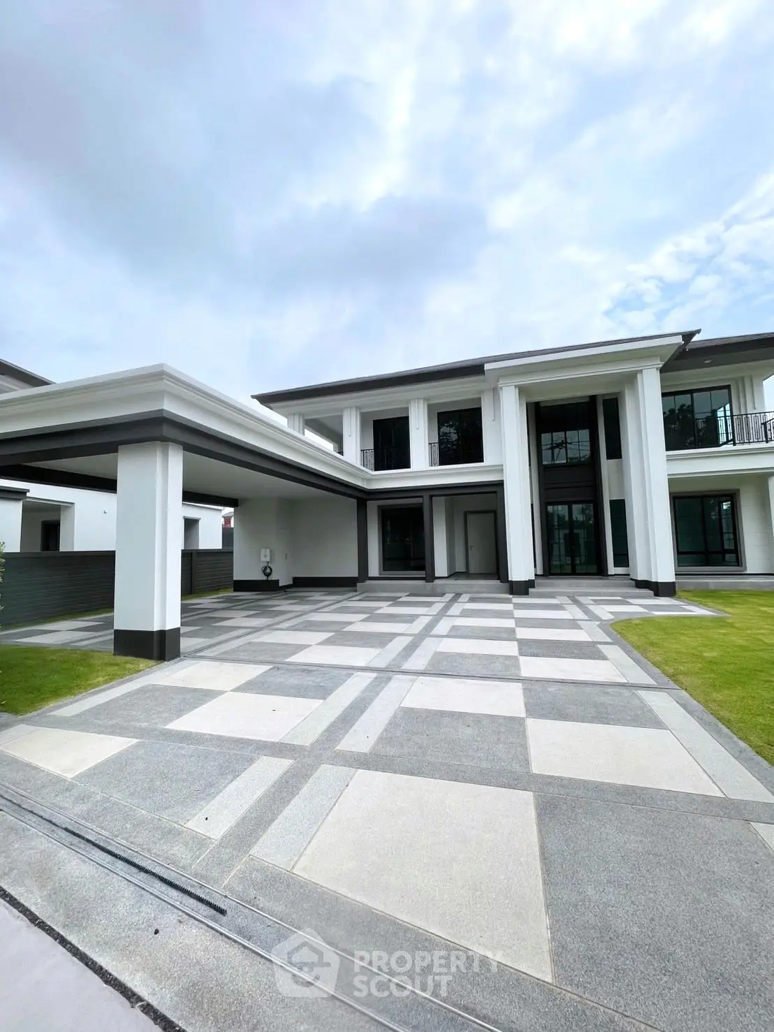Luxurious modern mansion with grand entrance and spacious driveway, perfect for upscale living.