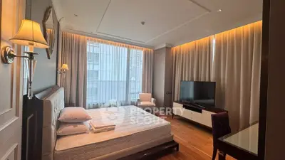 Luxurious bedroom with modern decor, large windows, and ambient lighting in a high-rise apartment.