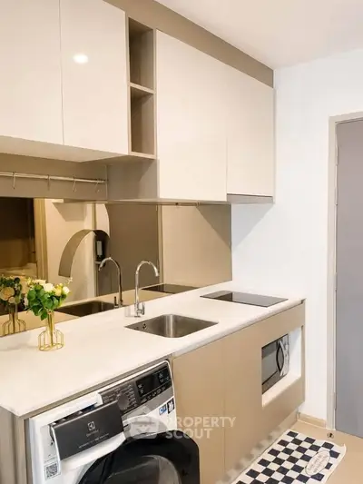 Modern kitchen with sleek cabinetry, built-in appliances, and stylish decor