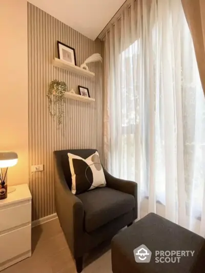 Cozy reading nook with armchair and natural light in modern apartment