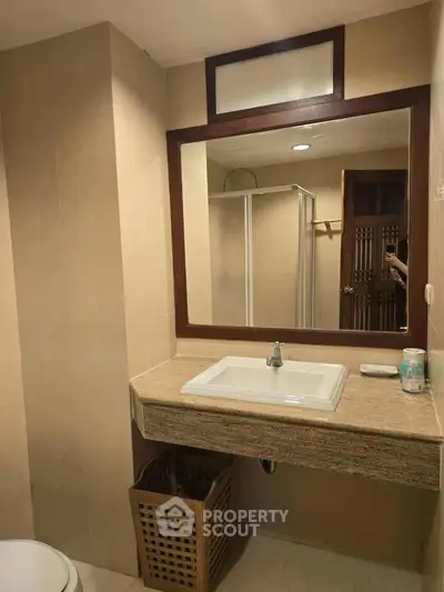 Elegant bathroom with modern sink and spacious shower area