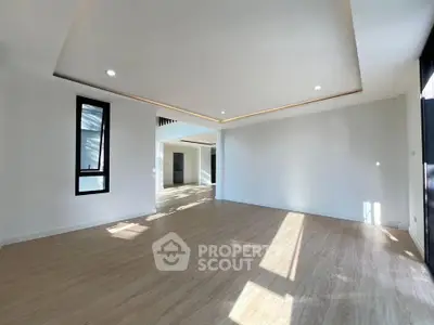 Spacious modern living room with wooden flooring and recessed lighting