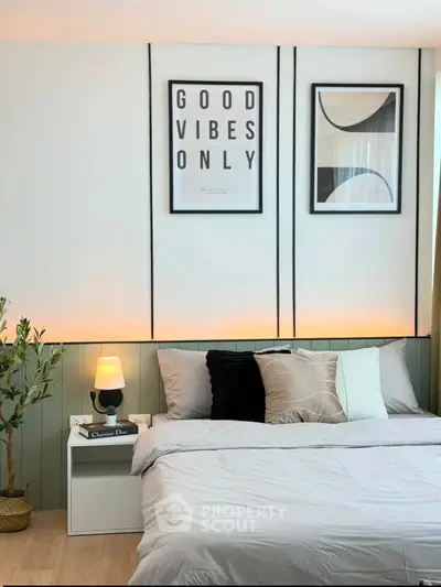 Modern bedroom with stylish decor and cozy ambiance, featuring elegant wall art and soft lighting.