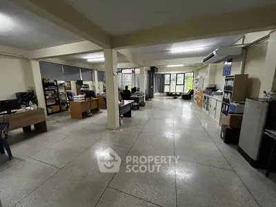 Spacious open-plan office with natural light and modern furnishings, ideal for collaborative workspaces.