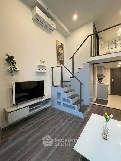 Modern duplex living room with stylish staircase and open kitchen layout
