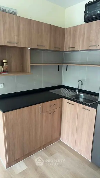Modern kitchen with sleek wooden cabinets and compact design