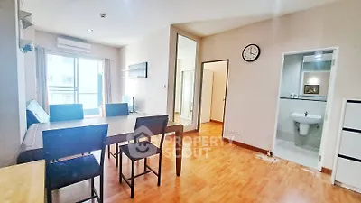 Spacious living area with dining set and modern decor