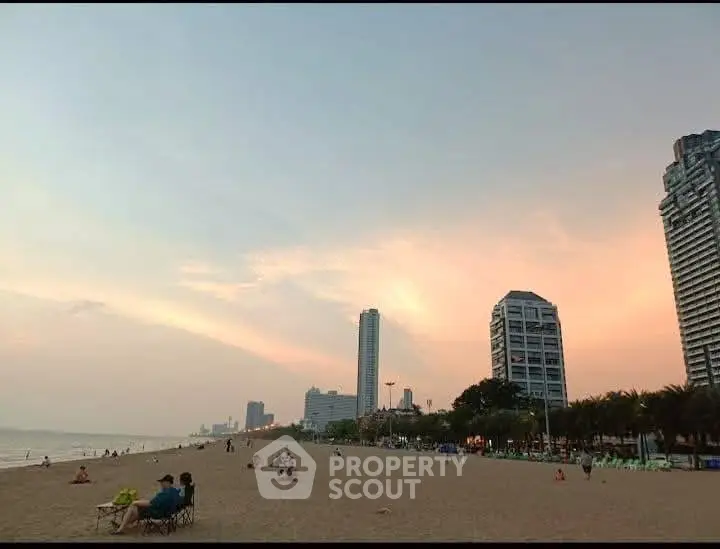 Stunning beachfront view with modern high-rise buildings at sunset