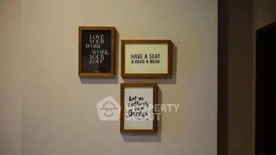 Cozy interior wall with motivational framed quotes in a stylish home.
