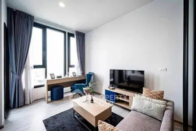 Modern living room with stylish furniture and large windows offering natural light.
