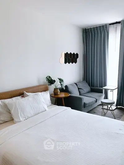 Modern bedroom with cozy seating area and stylish decor