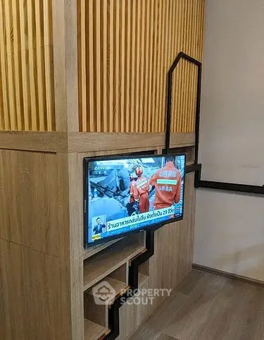 Modern interior with wooden paneling and mounted TV in a stylish living space.