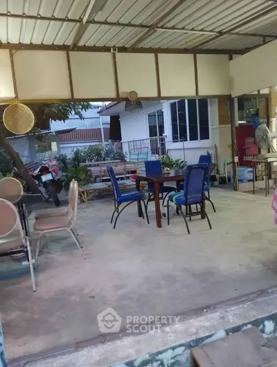 Charming outdoor patio with seating area and garden view, perfect for relaxation and entertaining.