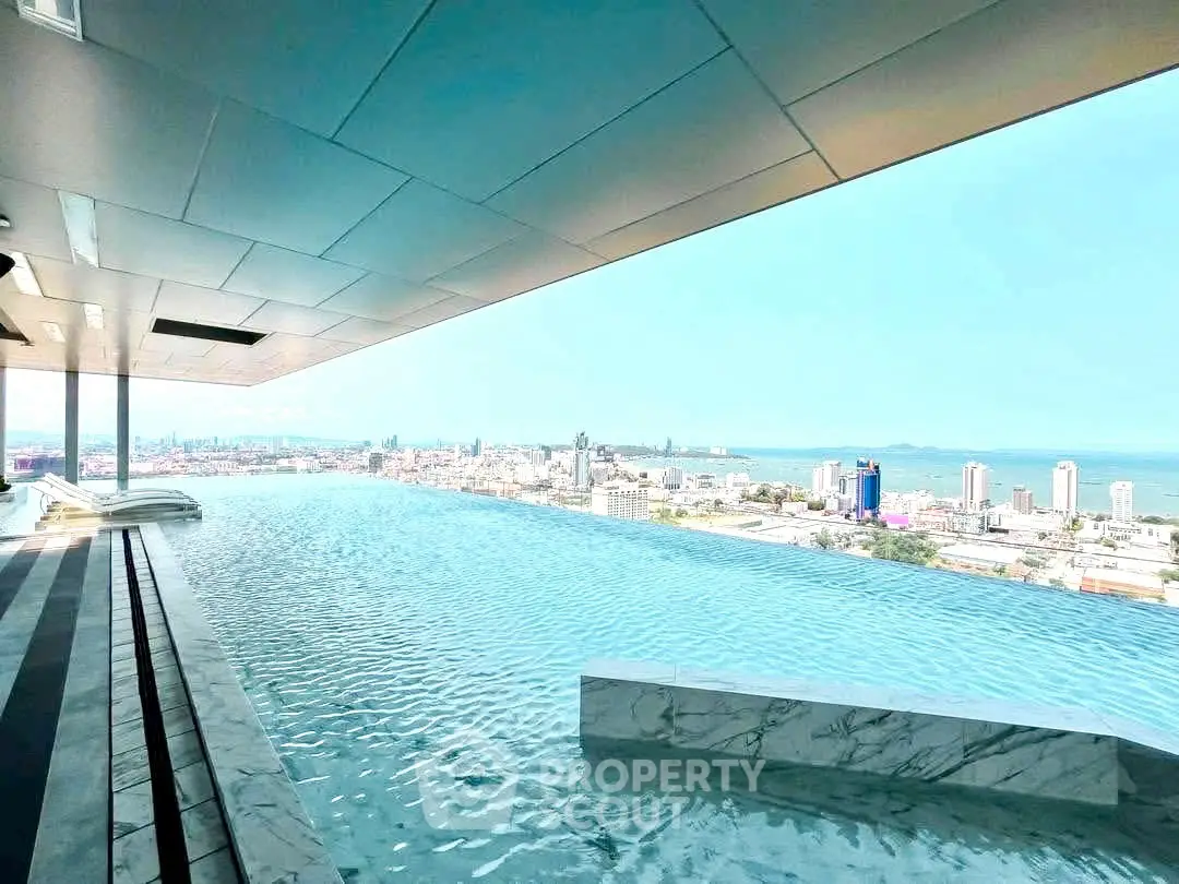 Luxurious rooftop infinity pool with stunning city and ocean views, perfect for upscale living.