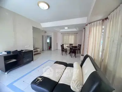 Spacious living room with dining area and modern furniture in a well-lit home.