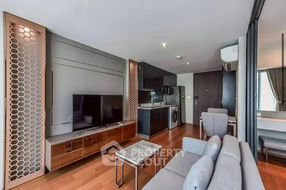 Modern living room with open kitchen and stylish furniture in a contemporary apartment.