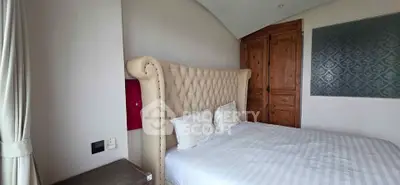 Luxurious bedroom with elegant tufted headboard and wooden accents