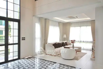 Luxurious modern living room with high ceilings and elegant decor