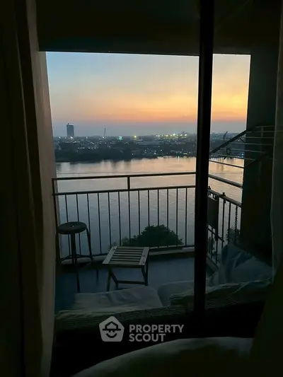 Stunning river view from a cozy balcony at sunset, perfect for relaxation and enjoying the serene atmosphere.