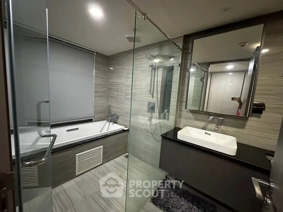 Luxurious modern bathroom with glass shower and bathtub