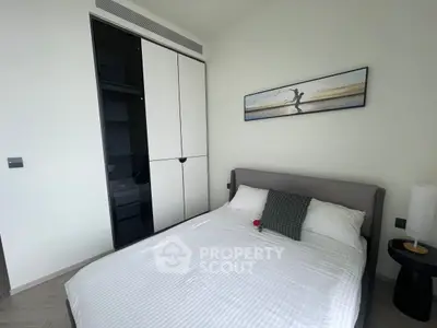 Modern bedroom with sleek wardrobe and stylish decor in a contemporary apartment.
