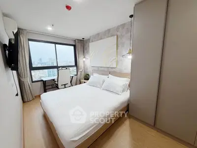 Modern bedroom with city view, stylish decor, and ample natural light.