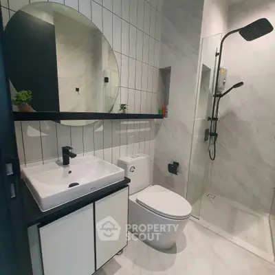 Modern bathroom with sleek fixtures and glass shower enclosure