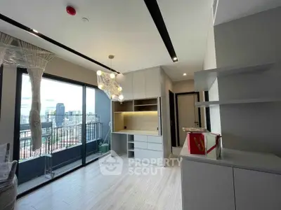 Modern living room with balcony and city view, featuring sleek cabinetry and stylish lighting.